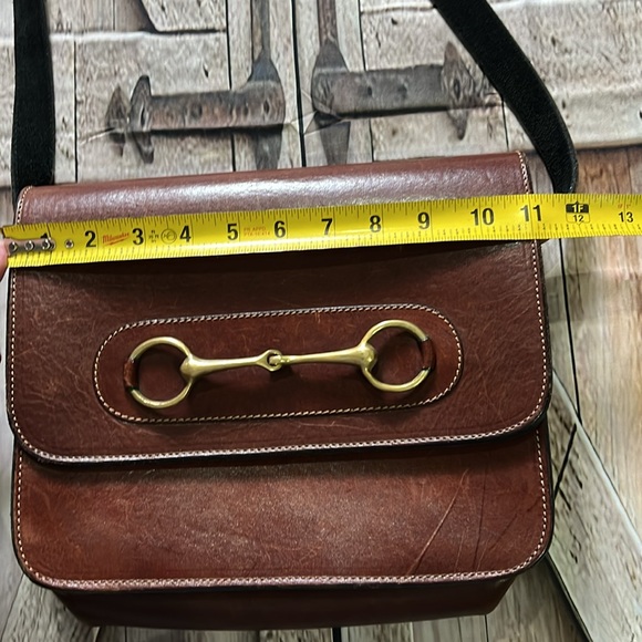 brown leather and features the gold-toned horsebit hardware.  B36 - Picture 2 of 9